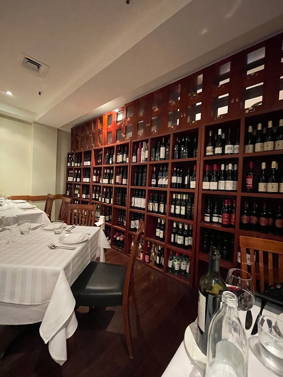 Mazzaro Restaurant dining room with wine shelving and white linen tables